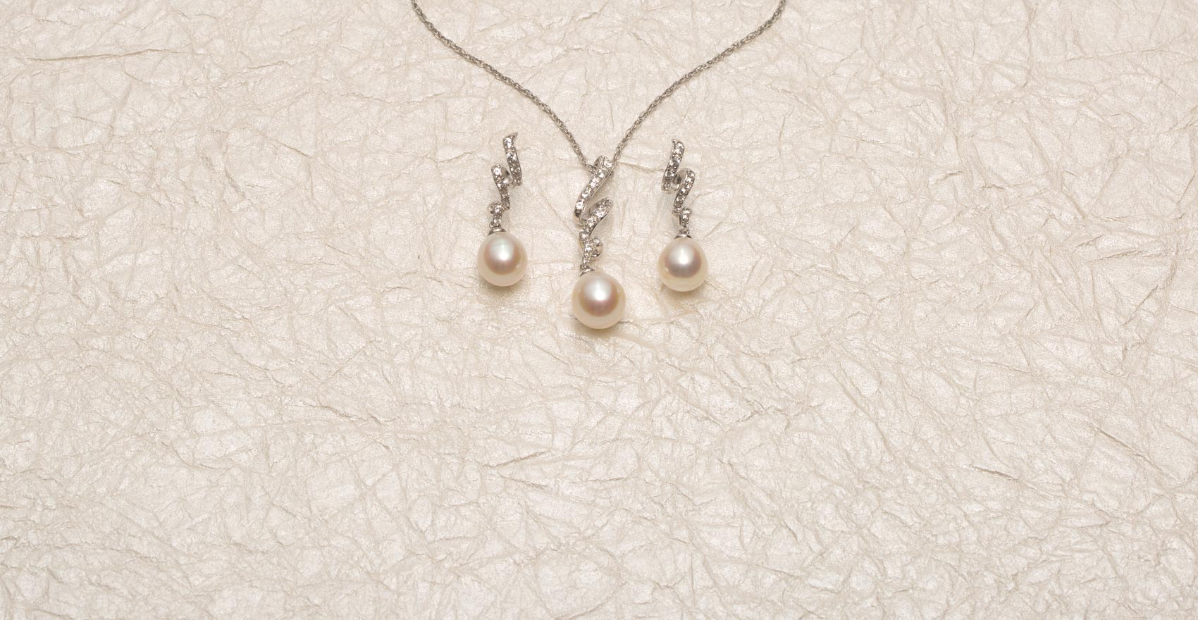 Pearl necklace with matching earrings on an onion-paper background