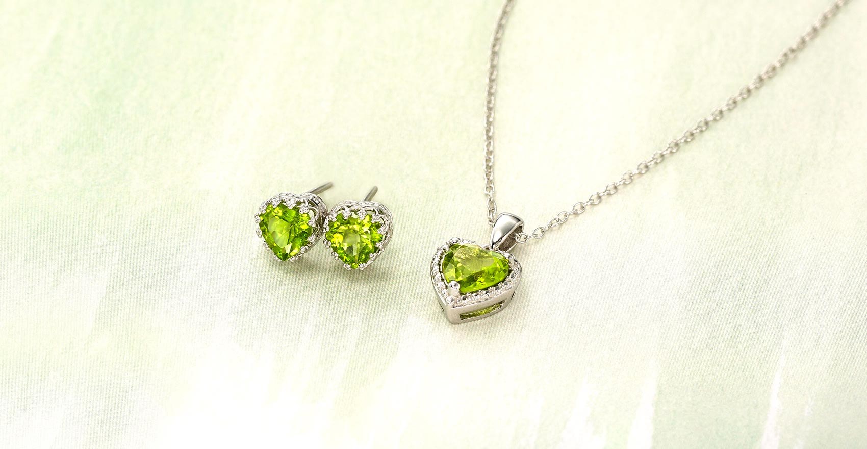 Peridot necklace and matching earrings on a marble background